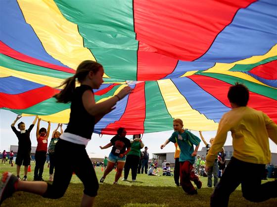 Aaron Marineau / The Hutchinson News via AP fileNickerson Elementary School third-graders dash under a rainbow colored tarp before it falls back down on them in Hutchinson, Kan., on April 25, 2013.